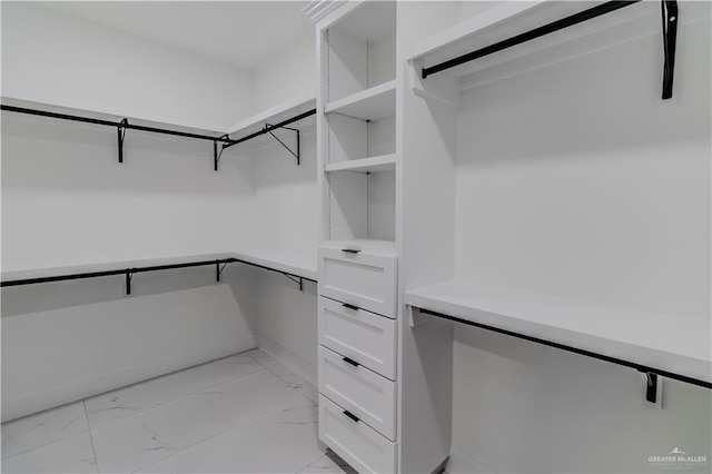 spacious closet with marble finish floor