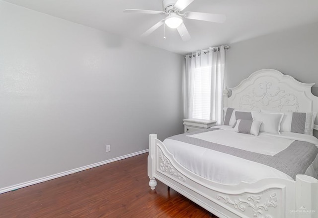 bedroom with dark wood-style floors, baseboards, and a ceiling fan