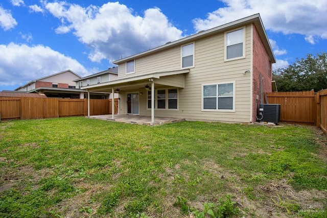 back of house featuring central AC, a yard, a patio area, and a fenced backyard