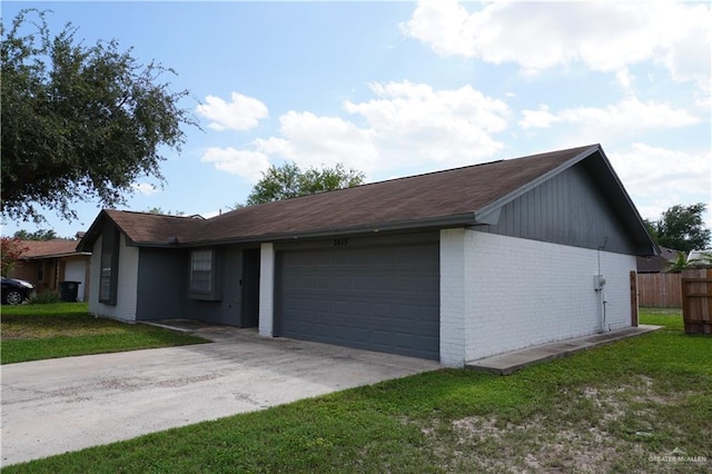2405 Sundrop Ave, Mission, TX 78574 - view of front of house featuring an attached garage, brick siding, and driveway