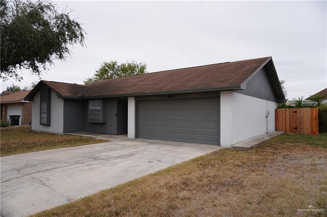 2405 Sundrop Ave, Mission, TX 78574 - ranch-style home with brick siding, a garage, and concrete driveway