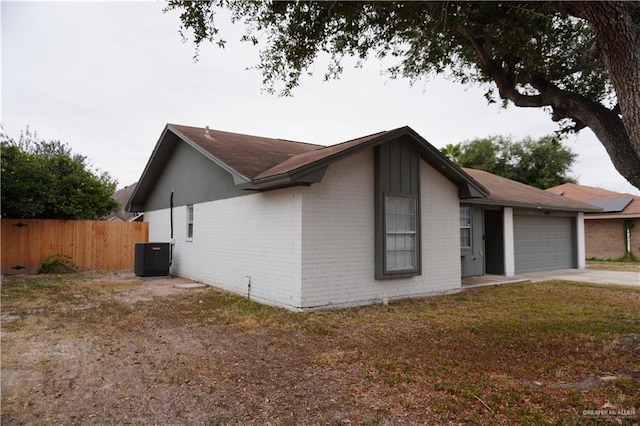 2405 Sundrop Ave, Mission, TX 78574 - view of side of home featuring a garage, brick siding, concrete driveway, and central AC unit