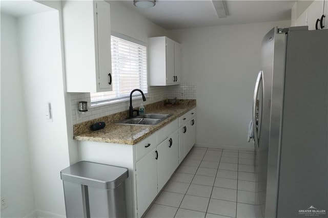 2405 Sundrop Ave, Mission, TX 78574 - kitchen with freestanding refrigerator, a sink, backsplash, white cabinetry, and light countertops