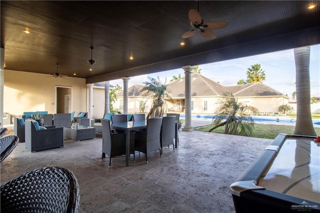 view of patio / terrace featuring outdoor dining space, an outdoor pool, ceiling fan, and an outdoor hangout area