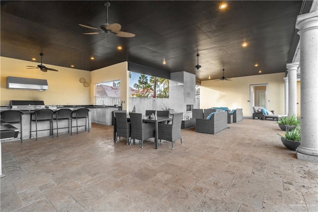 view of patio / terrace featuring a ceiling fan, outdoor dining area, outdoor lounge area, and an outdoor kitchen