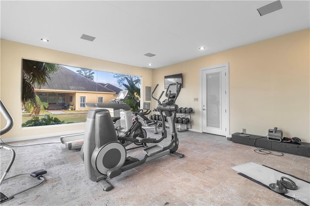 workout room featuring recessed lighting and baseboards