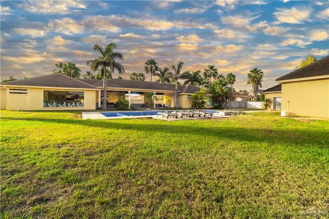 view of yard featuring a patio area, fence, and an outdoor pool