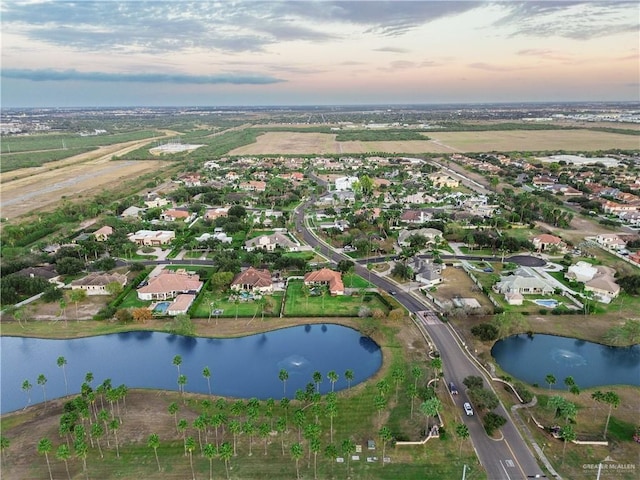 aerial view at dusk with a water view