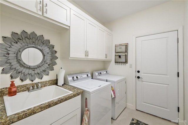 2803 Thompson St, Mission, TX 78573 - washroom with separate washer and dryer, cabinet space, and light tile patterned floors
