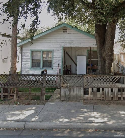 bungalow featuring fence