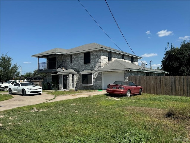 view of front of home with a front yard and a garage