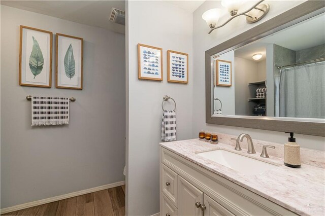 2105 Nightingale Ave W, Mcallen, TX 78504 - bathroom featuring vanity, wood finished floors, baseboards, and toilet
