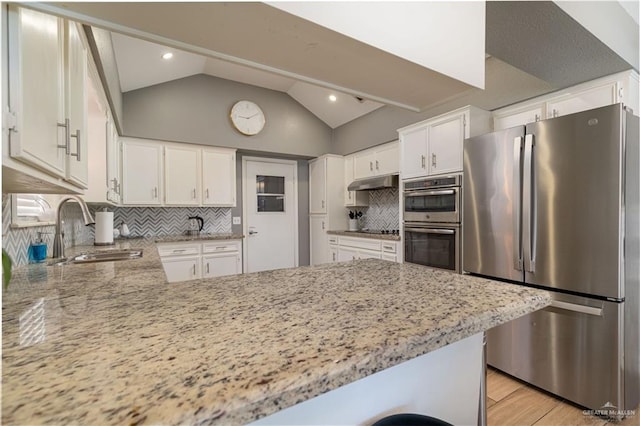 2105 Nightingale Ave W, Mcallen, TX 78504 - kitchen with stainless steel appliances, a sink, a peninsula, light stone countertops, and light wood-type flooring