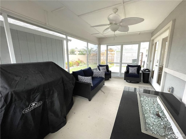 sunroom / solarium featuring ceiling fan