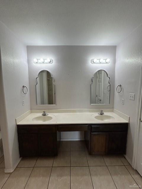 bathroom with double vanity, tile patterned floors, and a sink