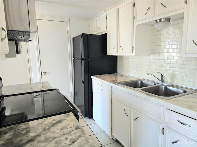 kitchen featuring white cabinets, sink, decorative backsplash, light tile patterned flooring, and range