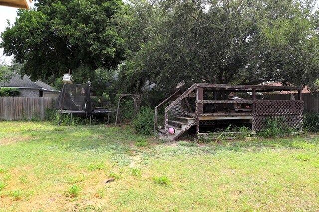 1811 Crown Pointe Blvd, Mission, TX 78572 - view of yard featuring a deck, fence, and a trampoline