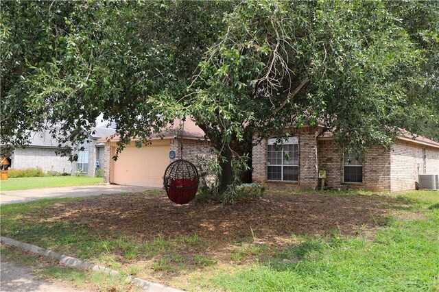1811 Crown Pointe Blvd, Mission, TX 78572 - view of property hidden behind natural elements with brick siding, a garage, central AC, and concrete driveway
