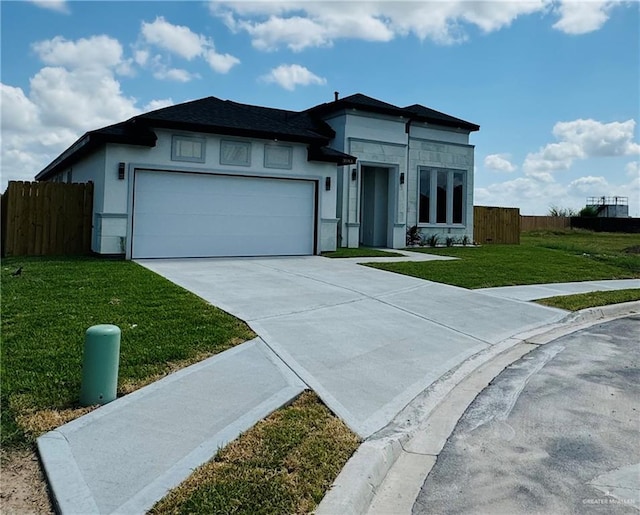 view of front of home with a garage and a front lawn