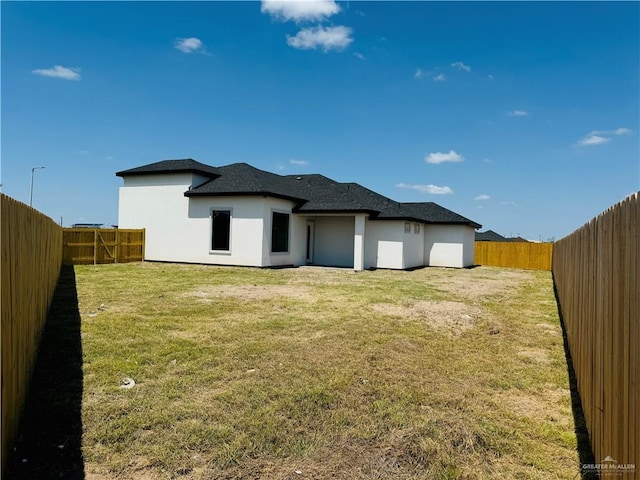 rear view of house with a yard