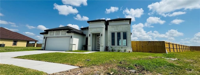 view of front of house with a front yard and a garage