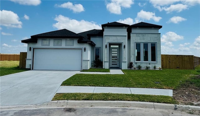 view of front of house with a front lawn and a garage