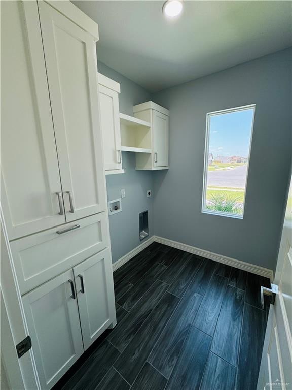 laundry room featuring electric dryer hookup, dark hardwood / wood-style floors, cabinets, and hookup for a washing machine