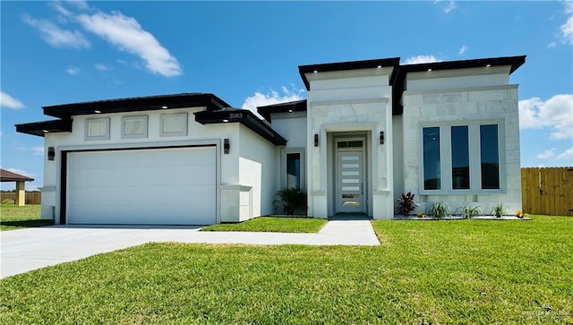 view of front of property featuring a front lawn and a garage