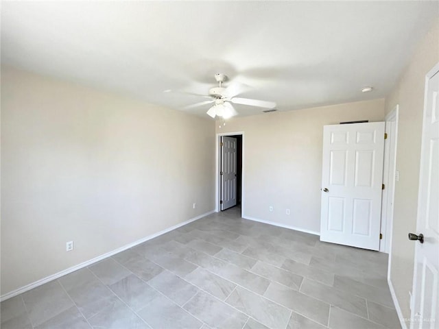 tiled empty room with ceiling fan