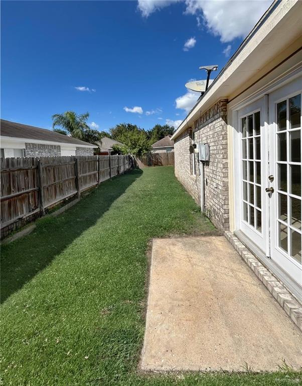 view of yard with french doors and a patio