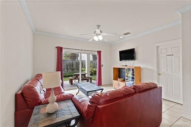 living area with visible vents, ornamental molding, a ceiling fan, light tile patterned flooring, and baseboards