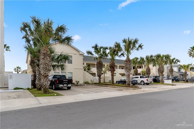 129 E Lantana St Unit 3, South Padre Island, TX 78597 - view of building exterior with uncovered parking and a residential view