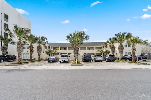 129 E Lantana St Unit 3, South Padre Island, TX 78597 - view of property featuring uncovered parking and a residential view