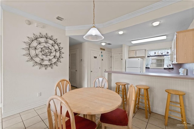 129 E Lantana St Unit 3, South Padre Island, TX 78597 - dining room with visible vents, crown molding, baseboards, and light tile patterned floors