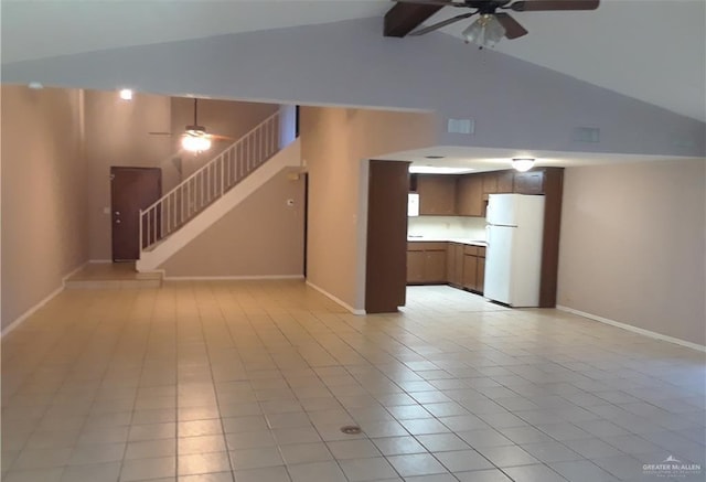 unfurnished living room featuring ceiling fan, light tile patterned flooring, and vaulted ceiling with beams