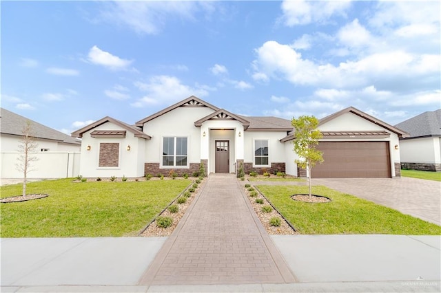 view of front of home with driveway, a front lawn, an attached garage, stone siding, and stucco siding