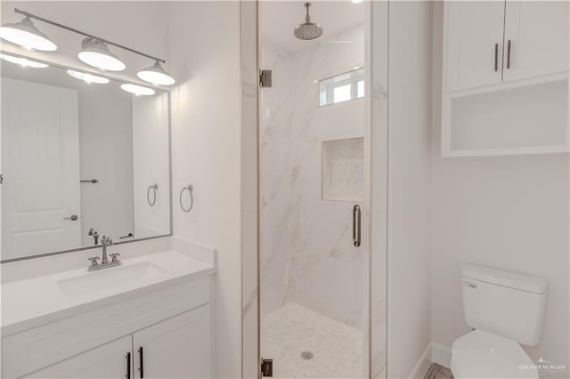 bathroom featuring vanity, a marble finish shower, and toilet