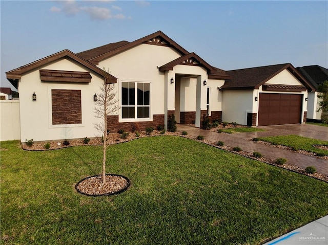 view of front of property featuring an attached garage, stucco siding, and stone siding