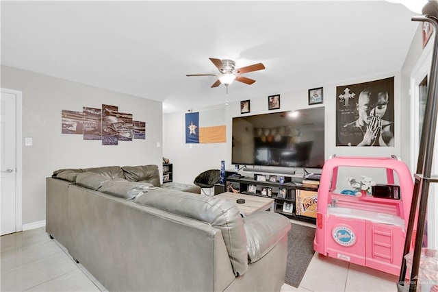 living area featuring a ceiling fan and tile patterned flooring