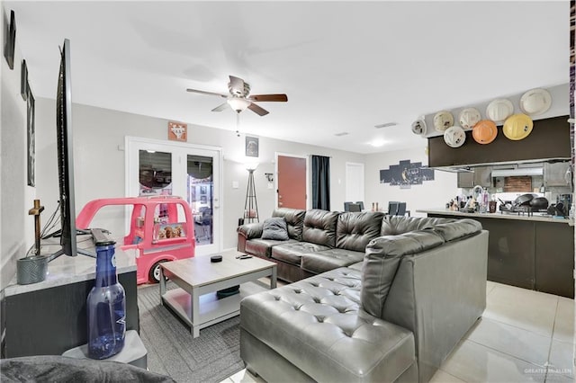 living area featuring light tile patterned floors, visible vents, and a ceiling fan