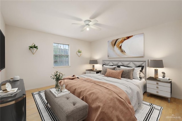 bedroom with ceiling fan and light hardwood / wood-style floors