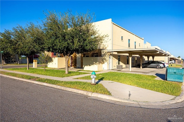 view of front facade featuring a carport and a front yard