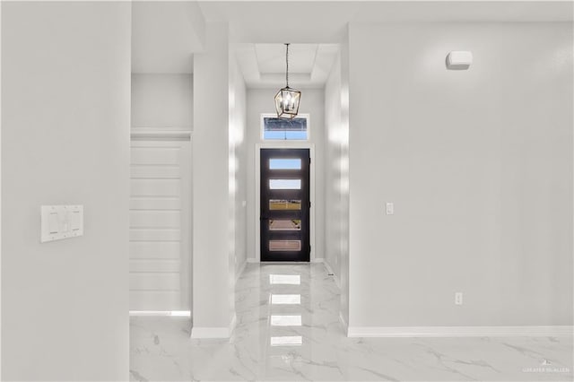 foyer entrance featuring a notable chandelier