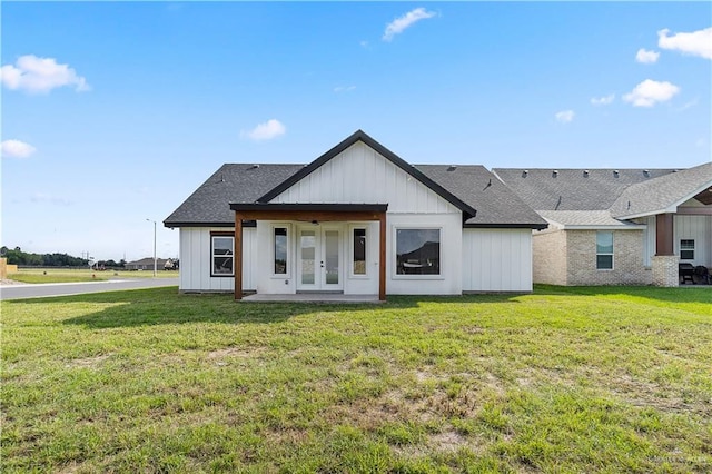 view of front of home featuring a front lawn and french doors