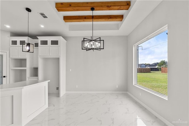 unfurnished dining area featuring beam ceiling, plenty of natural light, and a chandelier