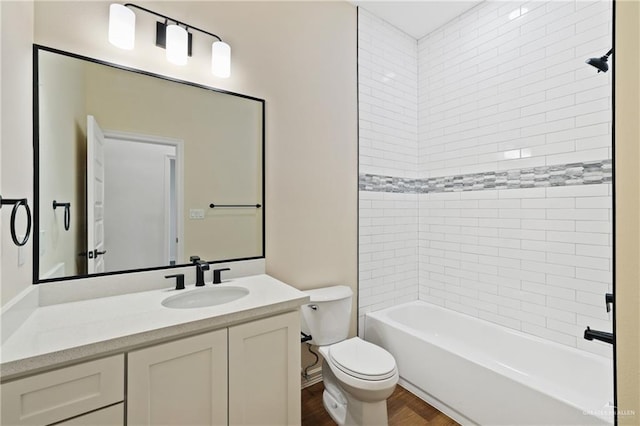 full bathroom featuring toilet,  shower combination, wood finished floors, and vanity