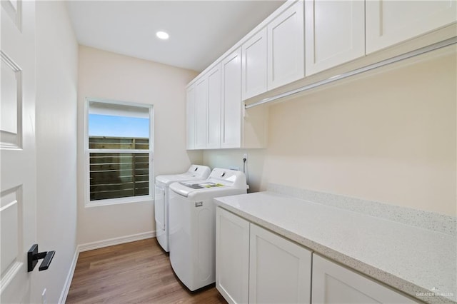 laundry area featuring cabinet space, baseboards, washing machine and clothes dryer, light wood-type flooring, and recessed lighting