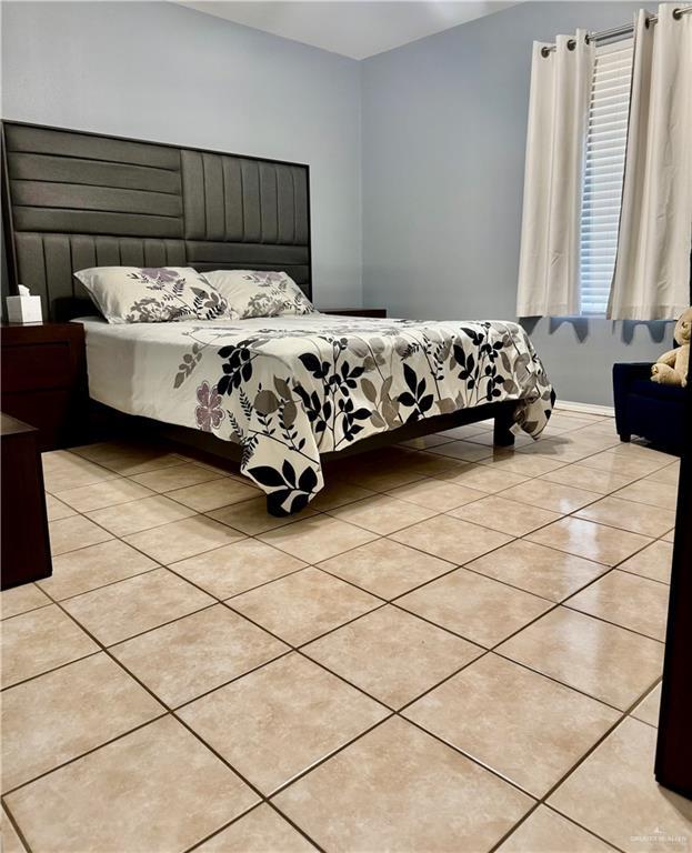 bedroom with light tile patterned flooring