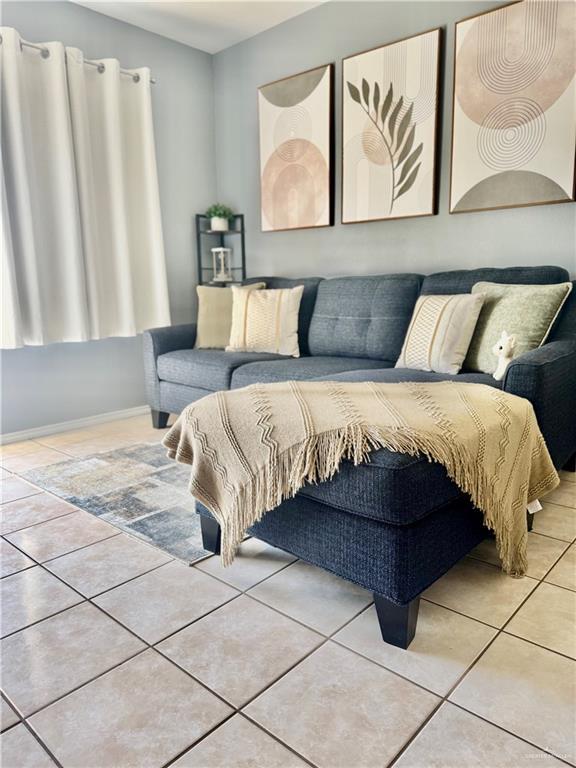 living room featuring baseboards and tile patterned floors