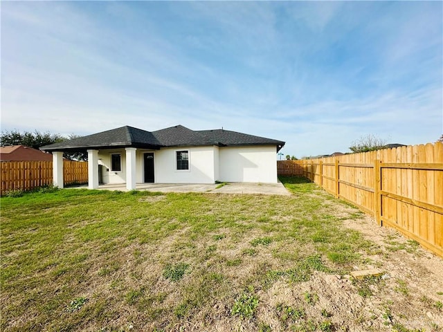 back of house featuring a yard and a patio area